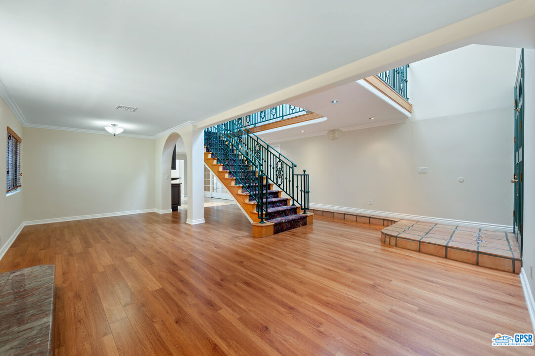 3290 Malcolm Avenue Los Angeles, CA 90034 - Photo 10 of 58 a view of an empty room with wooden floor