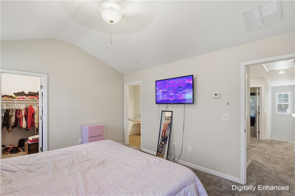 2555 Flat Shoals Road, Unit 2008 Atlanta, GA 30349 - Photo 23 of 33 a bedroom with a bed and a flat screen tv