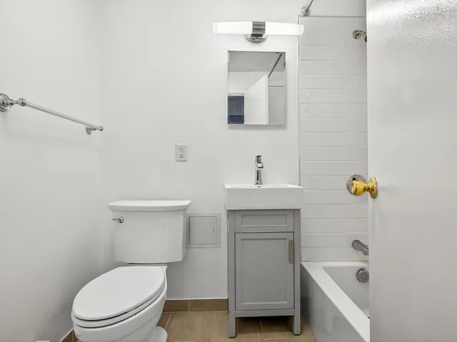 a bathroom with a sink a toilet and bathtub