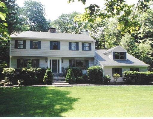 40 Hackberry Hill Road Weston, CT 06883 - Photo 1 of 1 a front view of a house with a yard and garage
