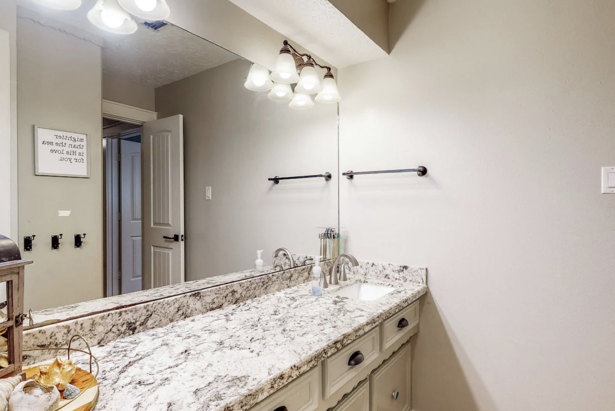 30819 Quinn Road Tomball, TX 77375 - Photo 17 of 30 a bathroom with a granite countertop sink a large mirror and vanity