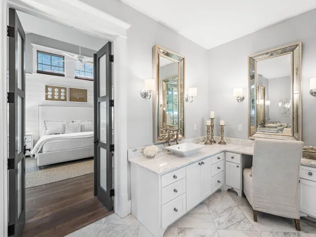 a bathroom with a tub a sink and a large mirror