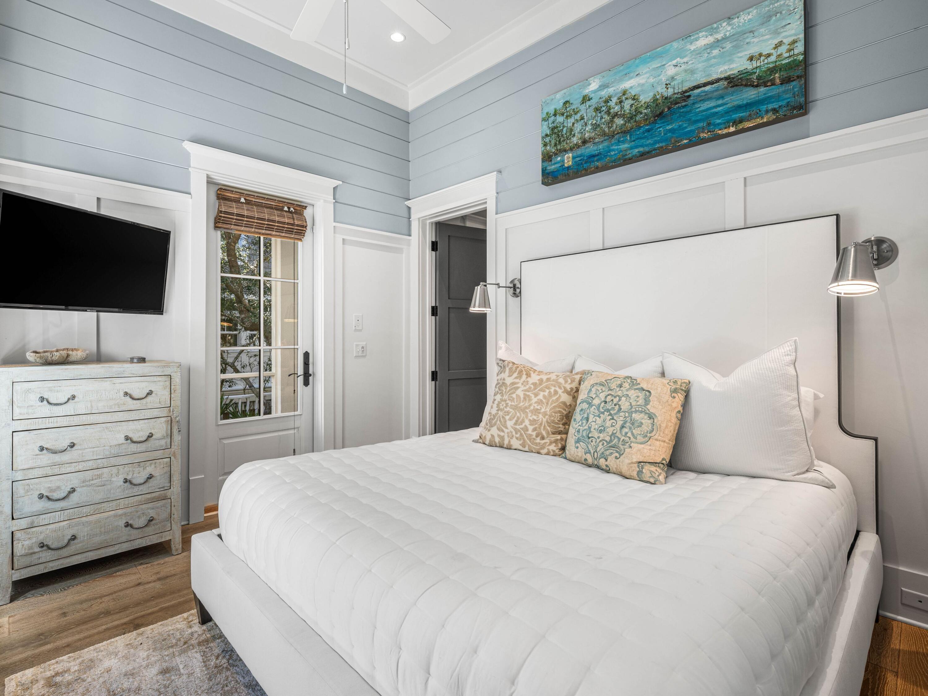 52 North Shingle Lane Watersound, FL 32461 - Photo 22 of 66 a bedroom with a bed and a flat tv screen on dresser