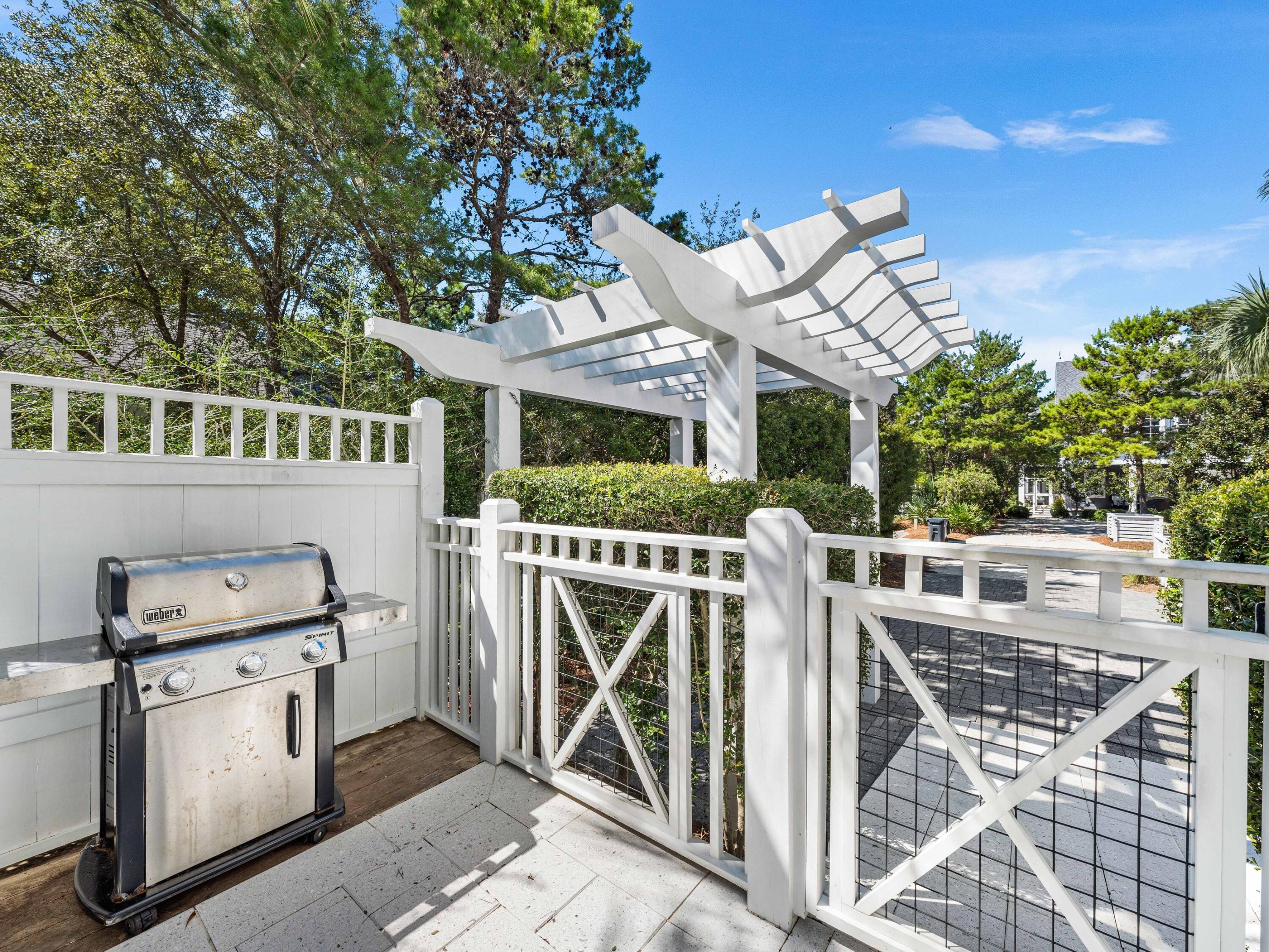 52 North Shingle Lane Watersound, FL 32461 - Photo 28 of 66 a view of a patio with table and chairs with wooden fence and plants