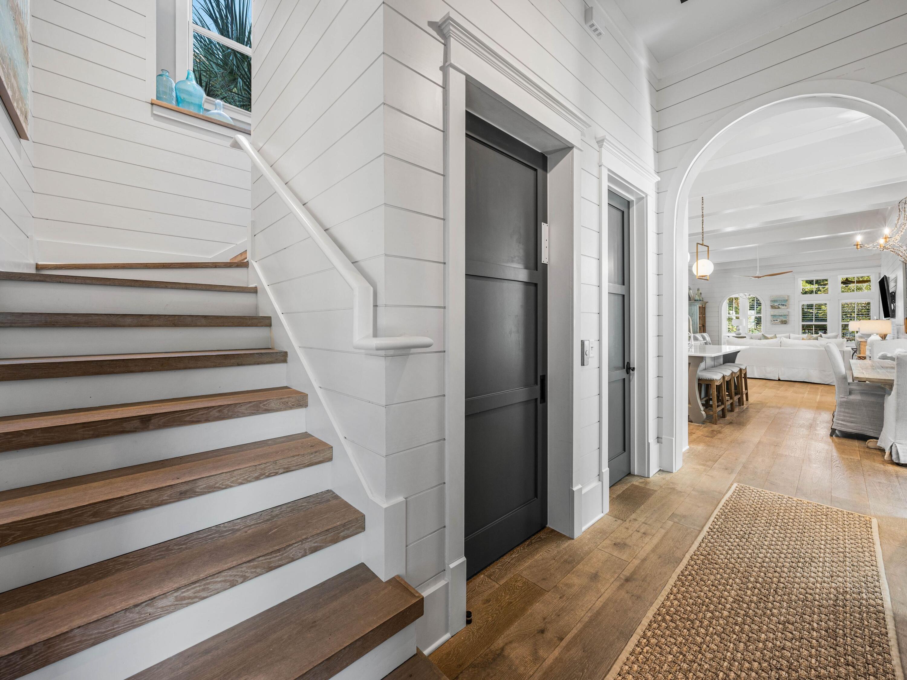 52 North Shingle Lane Watersound, FL 32461 - Photo 35 of 66 a view of a bedroom with wooden floor and a chandelier