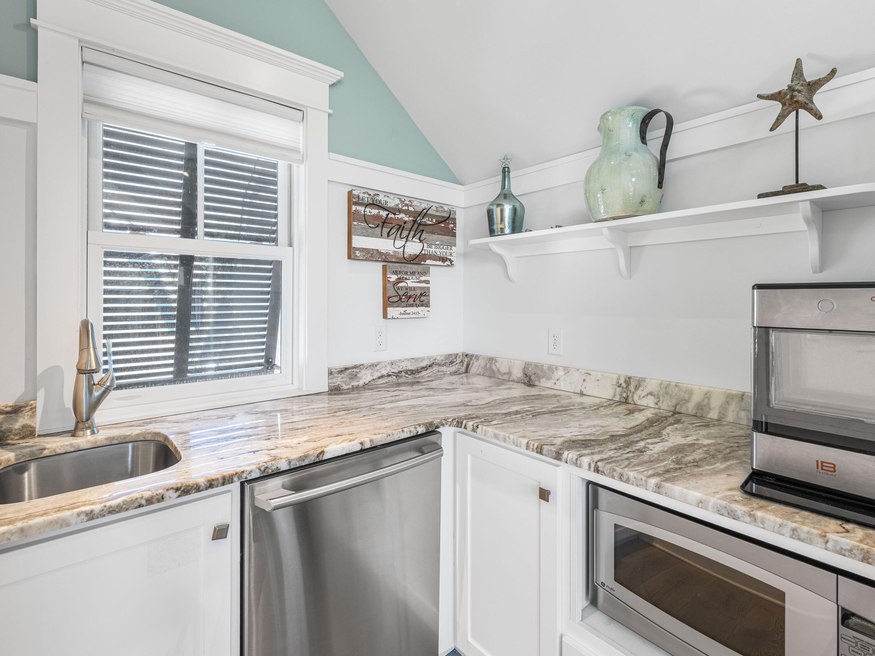 52 North Shingle Lane Watersound, FL 32461 - Photo 38 of 66 a kitchen with granite countertop a sink and a stove