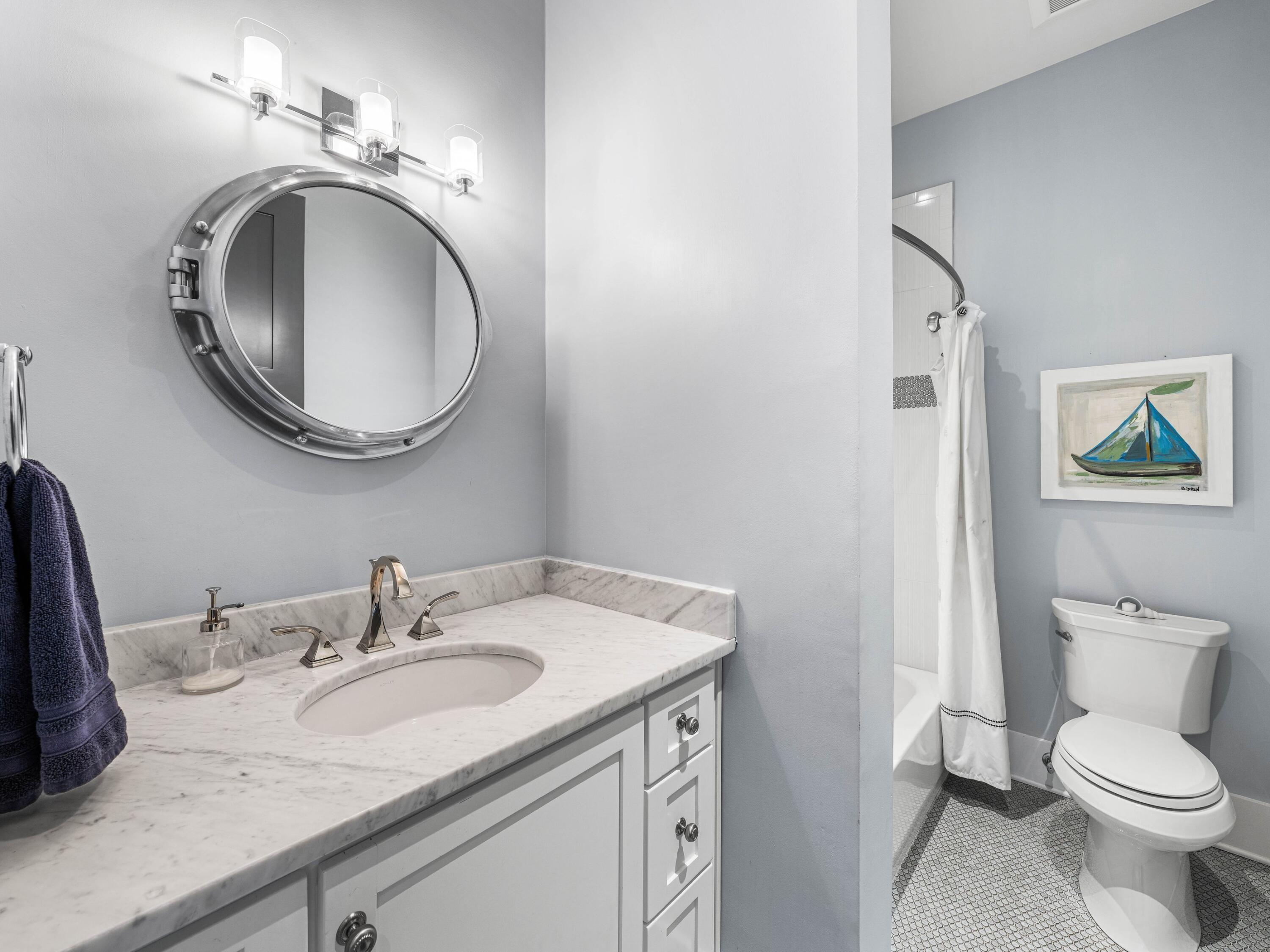 52 North Shingle Lane Watersound, FL 32461 - Photo 43 of 66 a bathroom with a granite countertop sink and a mirror