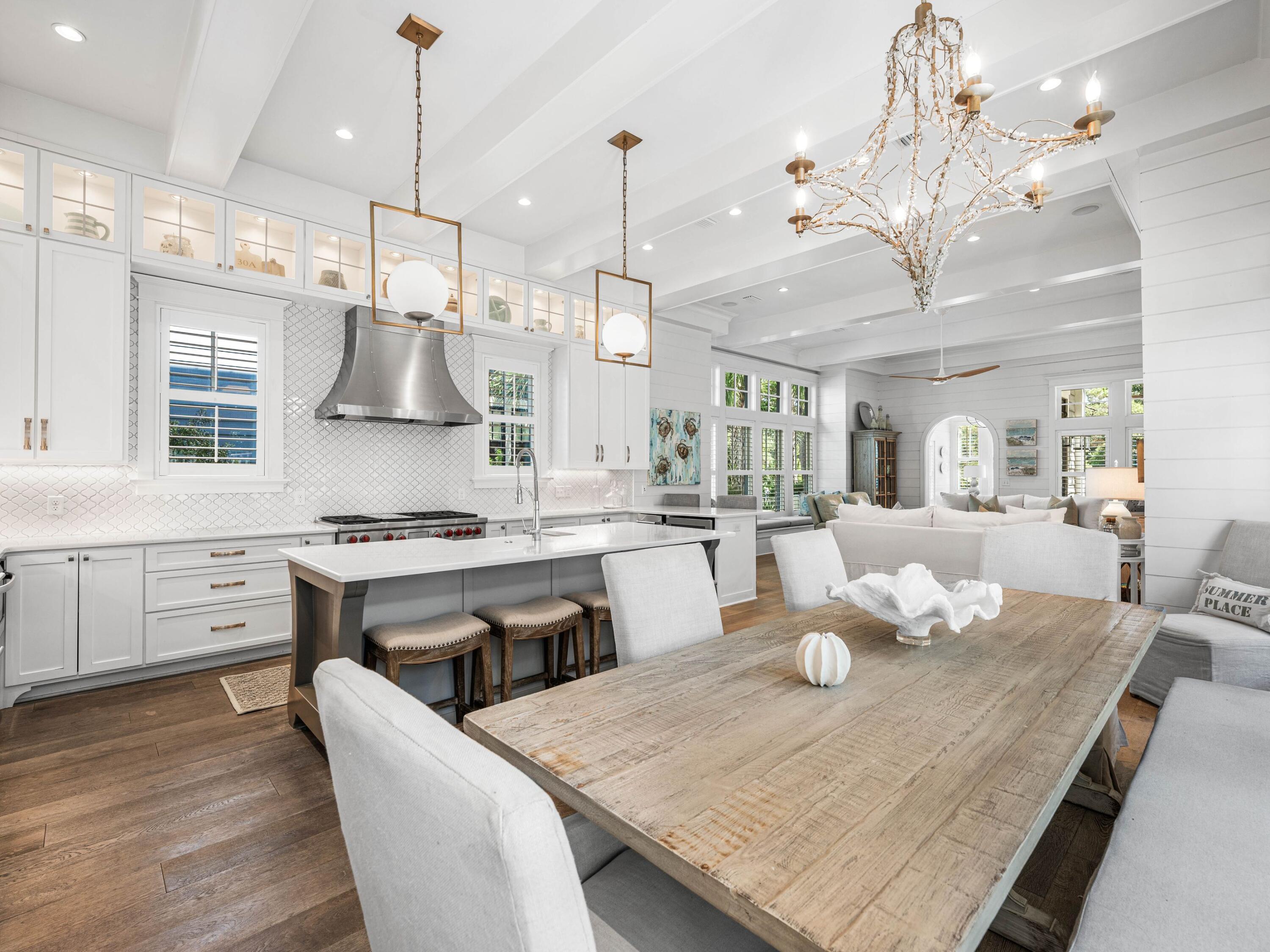 52 North Shingle Lane Watersound, FL 32461 - Photo 6 of 66 a large kitchen with kitchen island a stove a sink a center island and couches with wooden floor