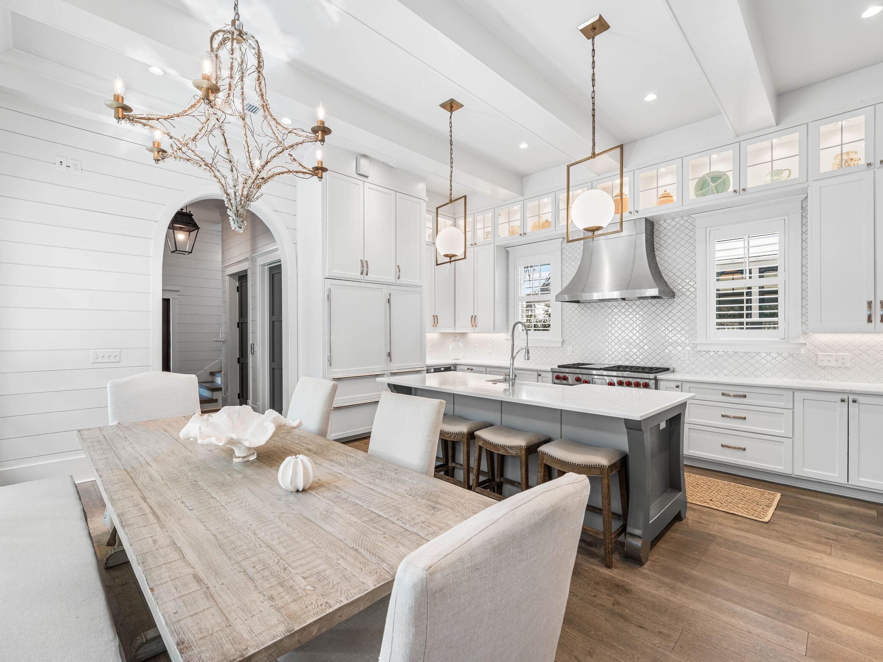 52 North Shingle Lane Watersound, FL 32461 - Photo 10 of 66 a large kitchen with granite countertop a table chairs stainless steel appliances and cabinets