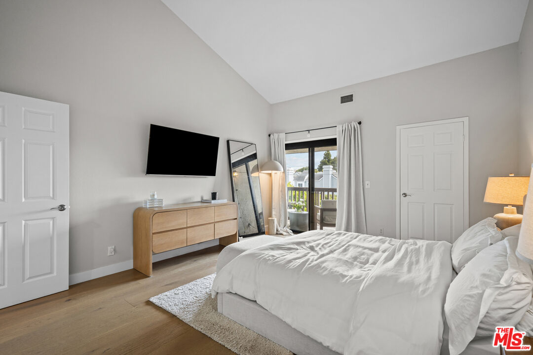 8601 Falmouth Avenue, Unit 404 Playa del Rey, CA 90293 - Photo 11 of 28 a bedroom with a bed and a flat screen tv