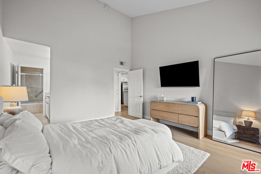 8601 Falmouth Avenue, Unit 404 Playa del Rey, CA 90293 - Photo 12 of 28 a bedroom with a bed and a flat screen tv
