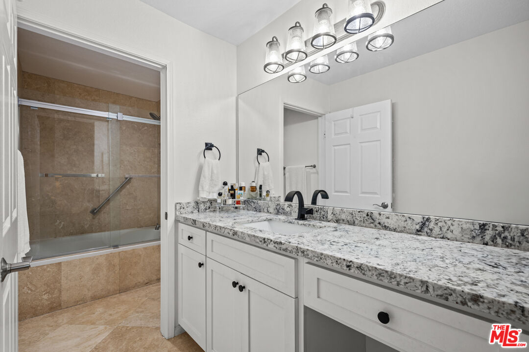 8601 Falmouth Avenue, Unit 404 Playa del Rey, CA 90293 - Photo 13 of 28 a bathroom with a granite countertop sink mirror and bathtub