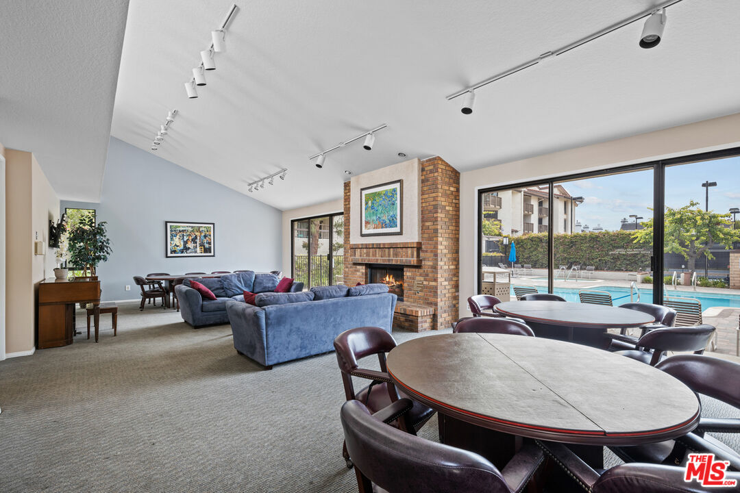 8601 Falmouth Avenue, Unit 404 Playa del Rey, CA 90293 - Photo 17 of 28 a living room with fireplace furniture and a large window