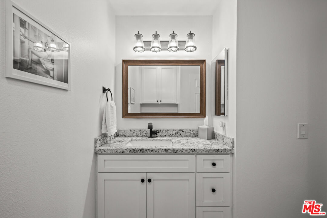 8601 Falmouth Avenue, Unit 404 Playa del Rey, CA 90293 - Photo 9 of 28 a bathroom with a sink and a mirror