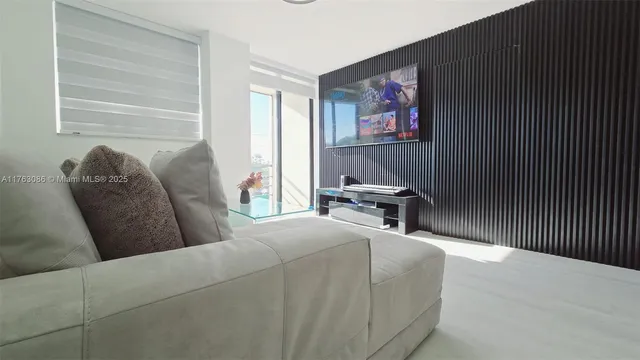 a reading room with furniture and a potted plant