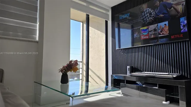 a view of a livingroom with wooden floor and window