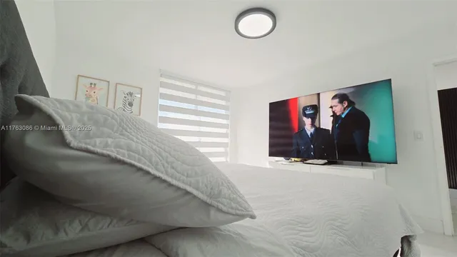 a bedroom with a bed and a painting on the wall