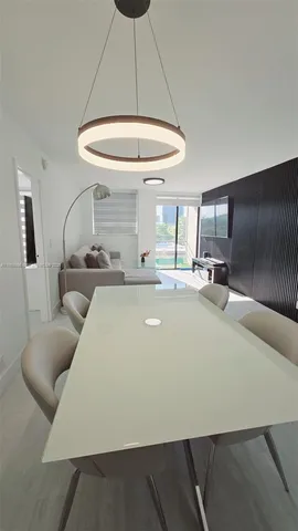 a room with a table chairs and a table