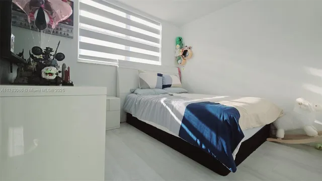 a living room with a couch and a potted plant