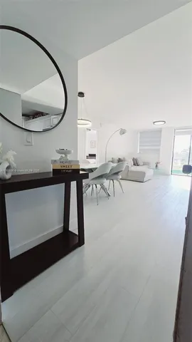 a room with a table chairs and a chandelier