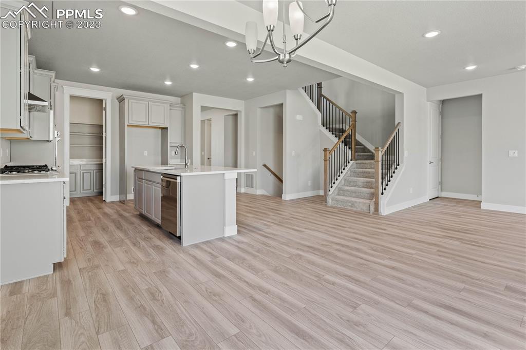 2154 Coyote Mint Drive Monument, CO 80132 - Photo 14 of 46 a living room with wooden floors and kitchen view