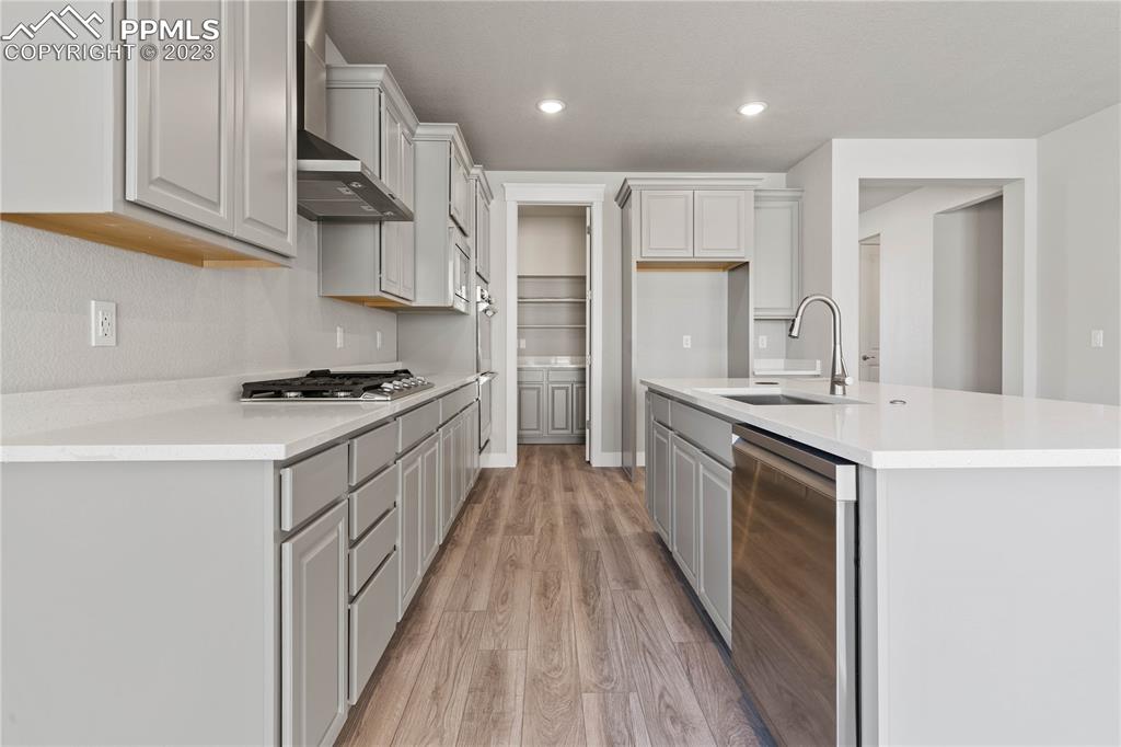 2154 Coyote Mint Drive Monument, CO 80132 - Photo 15 of 46 a kitchen with granite countertop a sink stove refrigerator and cabinets