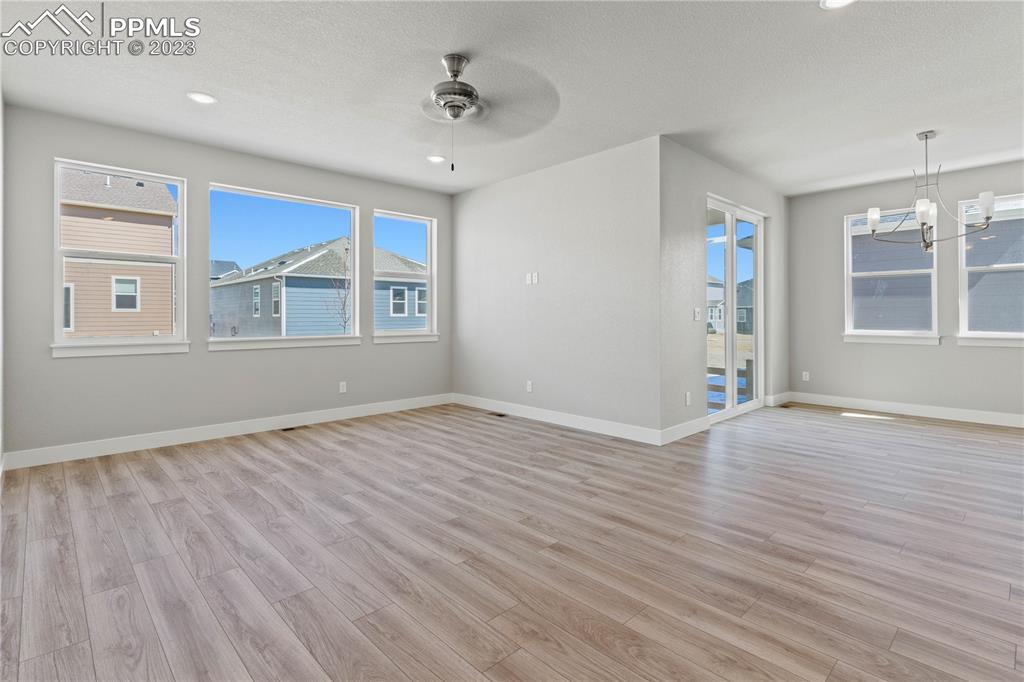 2154 Coyote Mint Drive Monument, CO 80132 - Photo 18 of 46 an empty room with wooden floor and windows