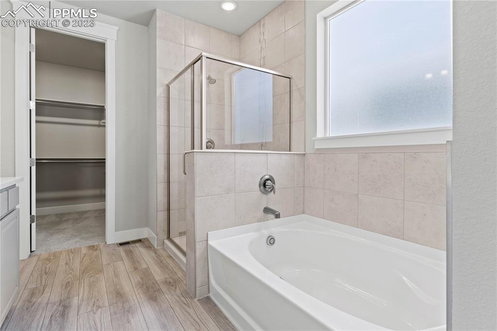 2154 Coyote Mint Drive Monument, CO 80132 - Photo 21 of 46 a bathroom with a bathtub and a shower