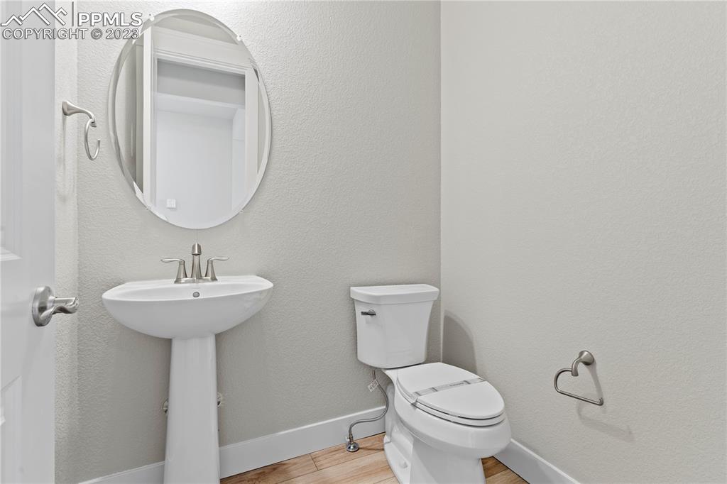 2154 Coyote Mint Drive Monument, CO 80132 - Photo 8 of 46 a bathroom with a toilet a sink and a mirror