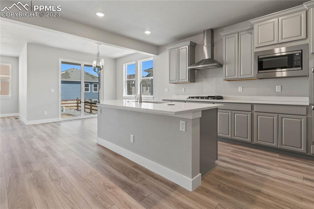 2154 Coyote Mint Drive Monument, CO 80132 - Photo 9 of 46 a kitchen with stainless steel appliances granite countertop a sink stove and microwave