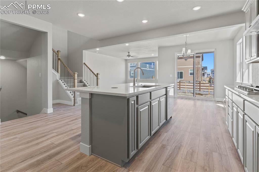 2154 Coyote Mint Drive Monument, CO 80132 - Photo 10 of 46 a kitchen with stainless steel appliances a sink and wooden floor