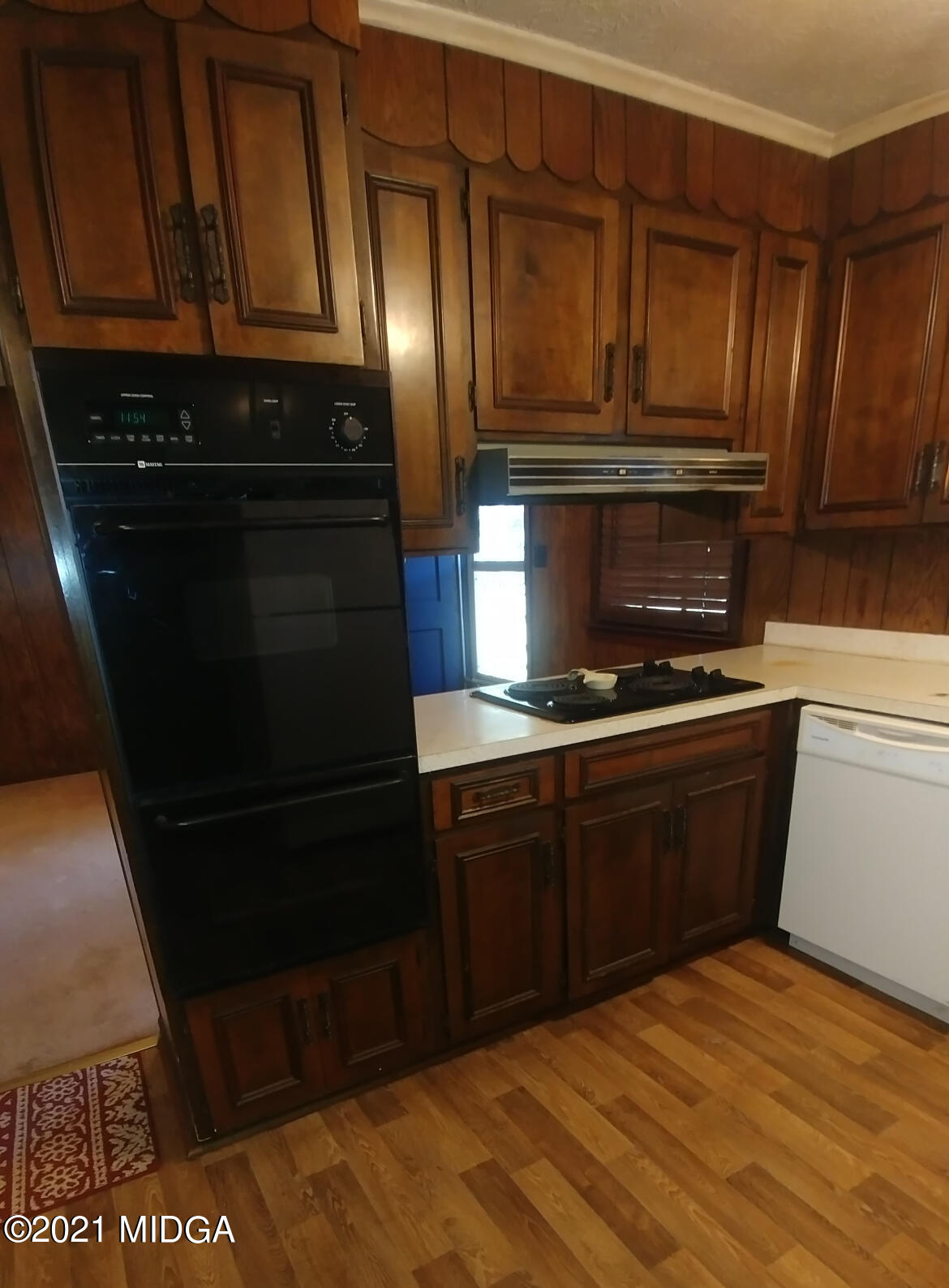 7325 Nowell Road South Macon, GA 31216 - Photo 3 of 18 a kitchen with a refrigerator and cabinets