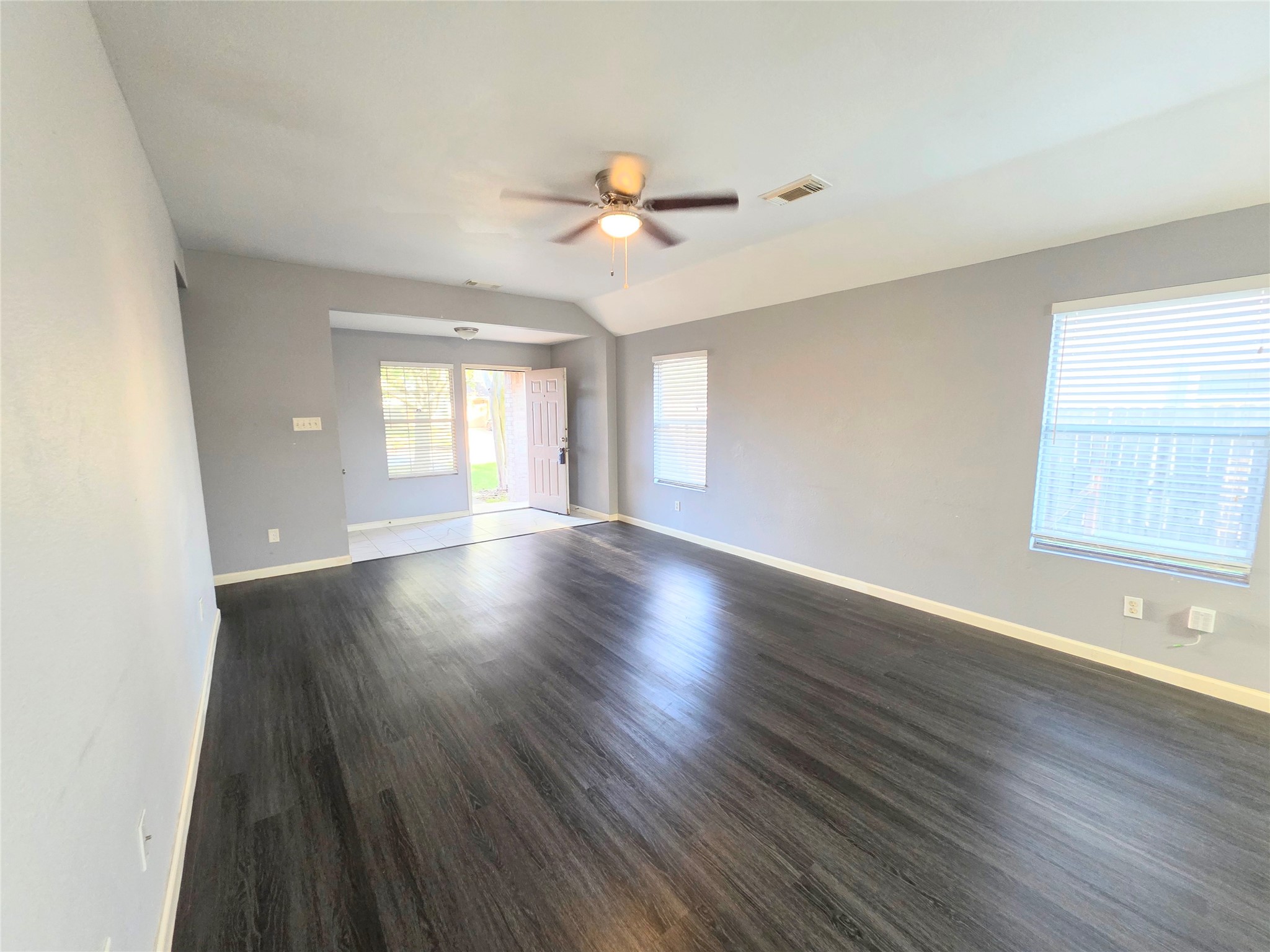 9514 Manorstone Court Houston, TX 77044 - Photo 1 of 9 a view of an empty room with wooden floor and a window