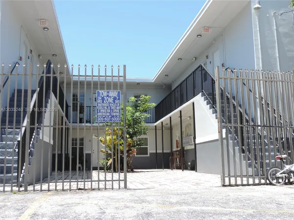 a view of street along with house and trees