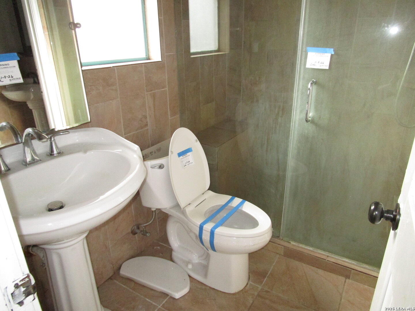7106 Timber Ridge Drive San Antonio, TX 78227 - Photo 11 of 13 a white toilet sitting next to a bathroom sink