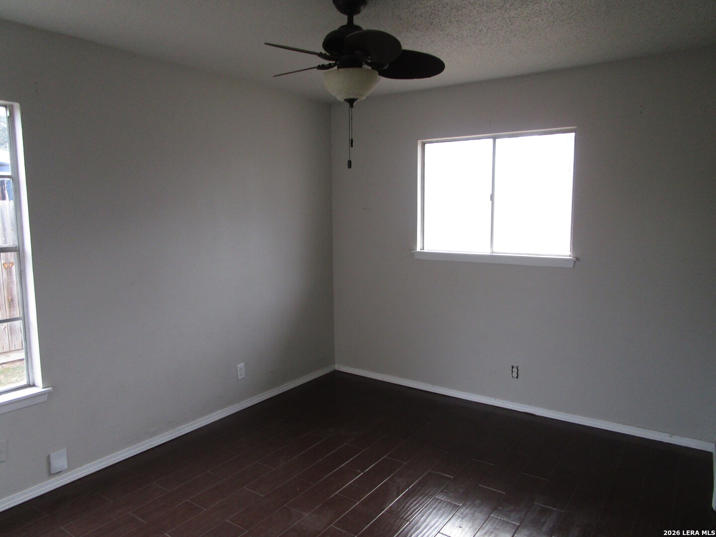 7106 Timber Ridge Drive San Antonio, TX 78227 - Photo 6 of 13 a view of an empty room with a window and wooden floor