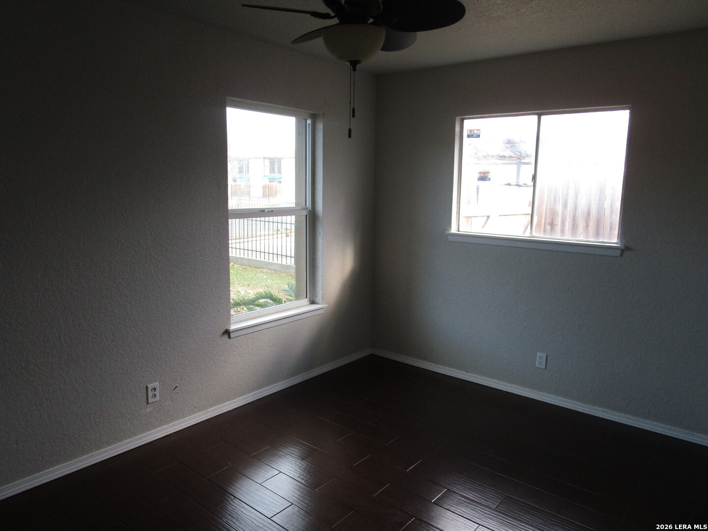 7106 Timber Ridge Drive San Antonio, TX 78227 - Photo 7 of 13 a view of an empty room with wooden floor and a window