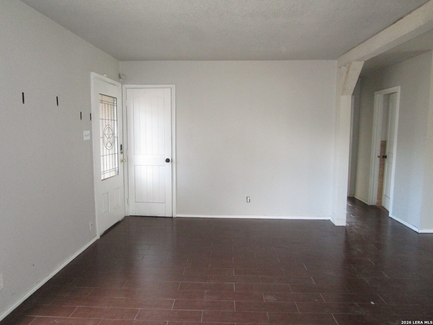 7106 Timber Ridge Drive San Antonio, TX 78227 - Photo 10 of 13 an empty room with wooden floor and windows