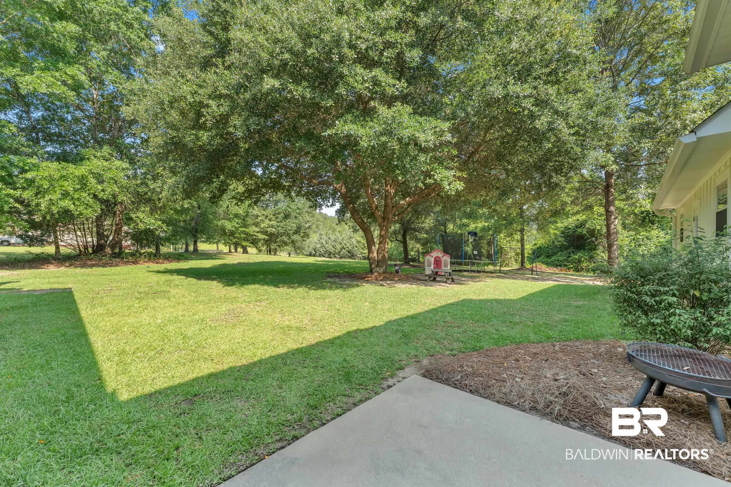 14531 Styx River Road Stapleton, AL 36578 - Photo 45 of 50 View of grassy yard with a patio area