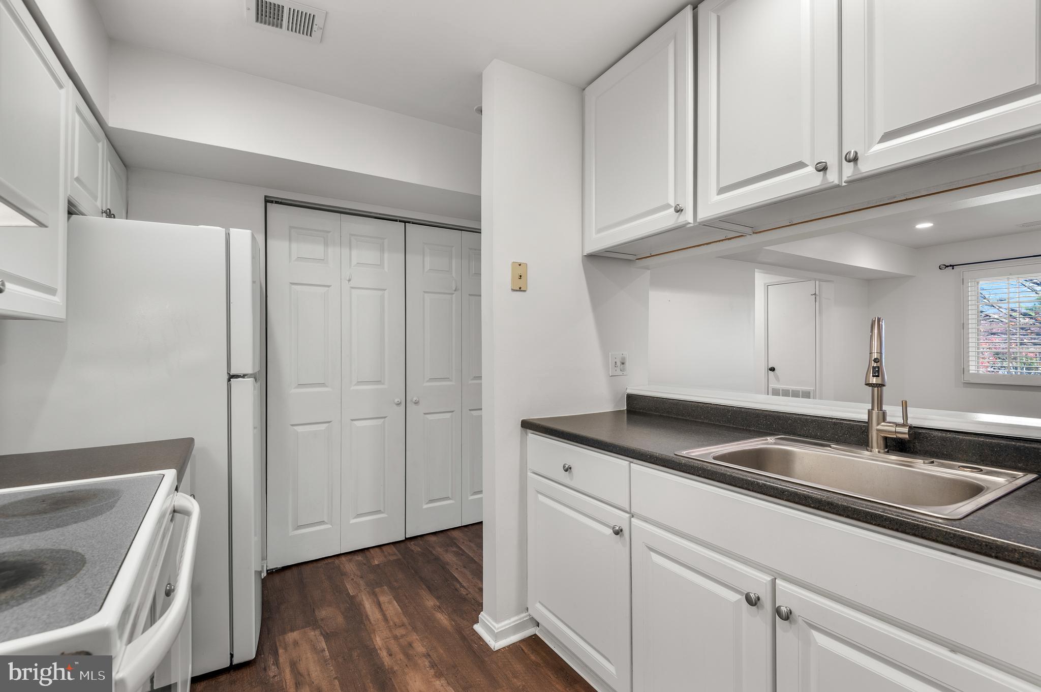 4942 Columbia Road, Unit 5 37 Columbia, MD 21044 - Photo 11 of 36 a kitchen with granite countertop a sink and a granite counter tops