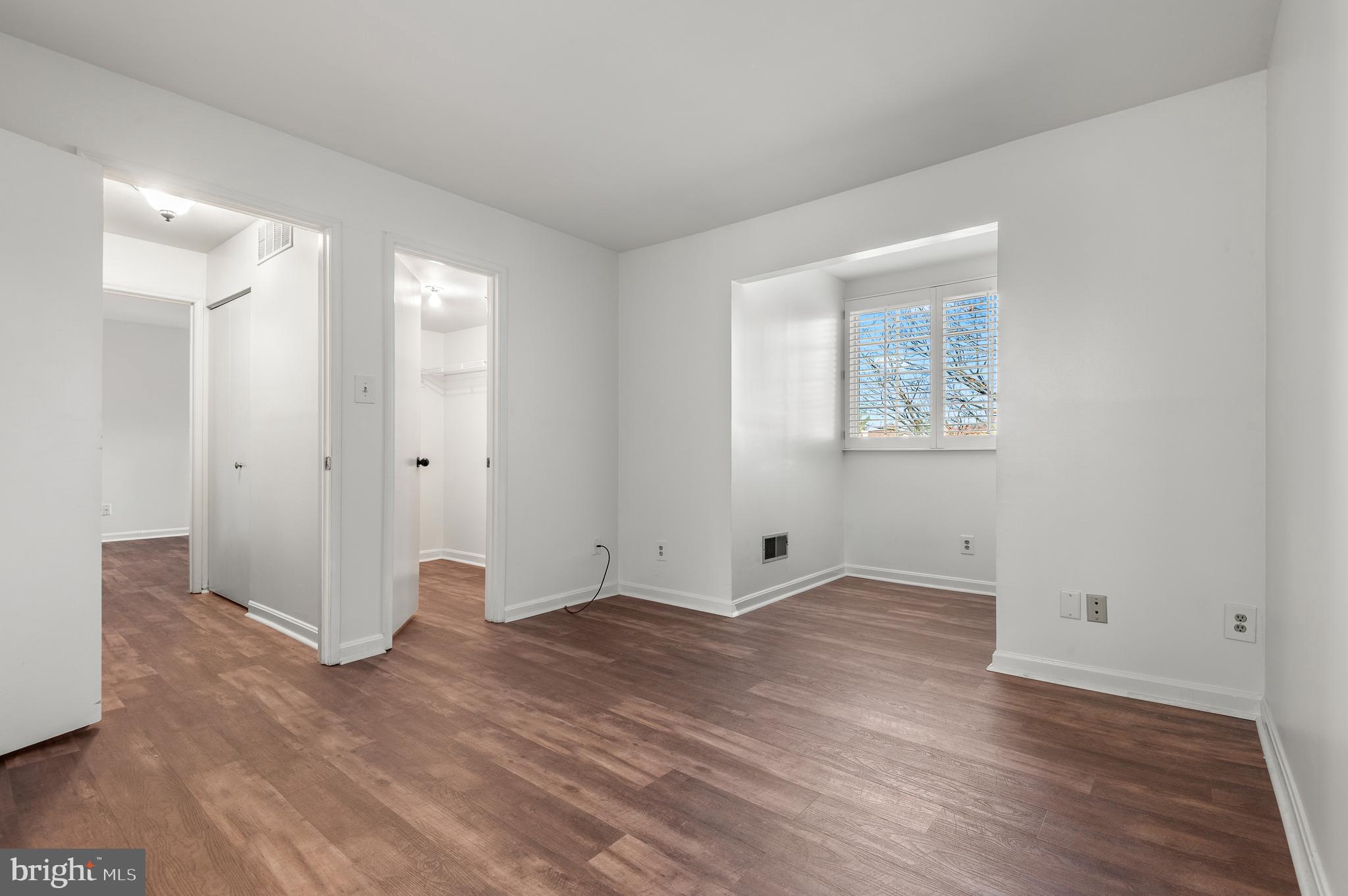 4942 Columbia Road, Unit 5 37 Columbia, MD 21044 - Photo 16 of 36 an empty room with wooden floor and windows