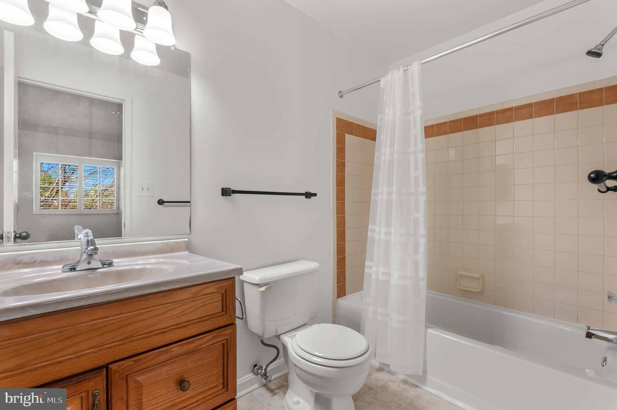 4942 Columbia Road, Unit 5 37 Columbia, MD 21044 - Photo 18 of 36 a bathroom with a sink a toilet and shower
