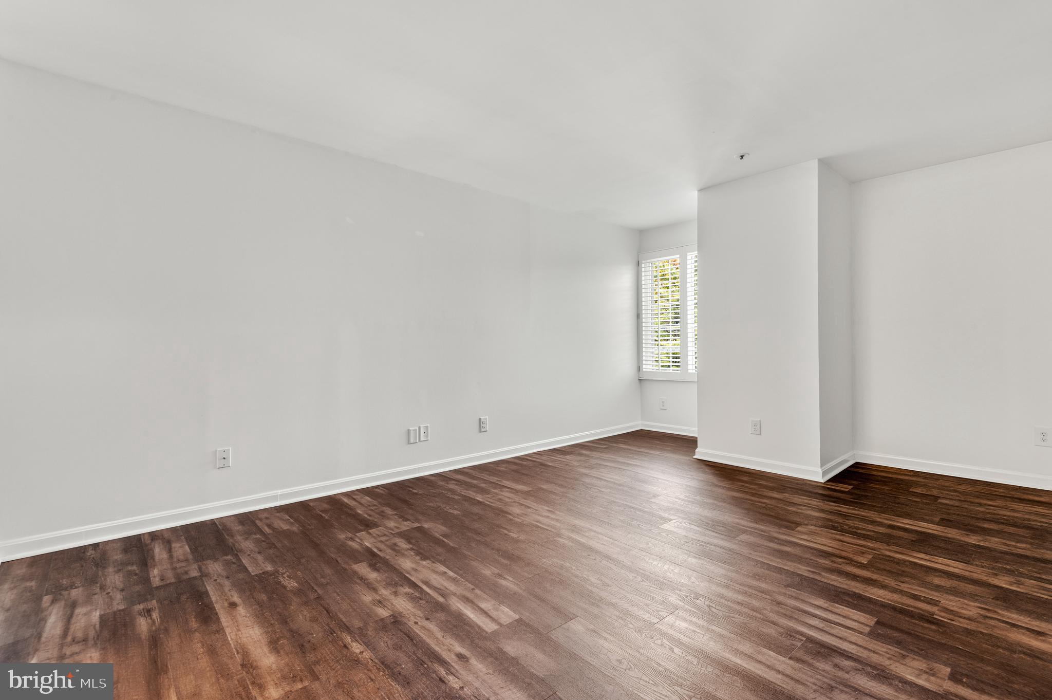 4942 Columbia Road, Unit 5 37 Columbia, MD 21044 - Photo 22 of 36 an empty room with wooden floor and window