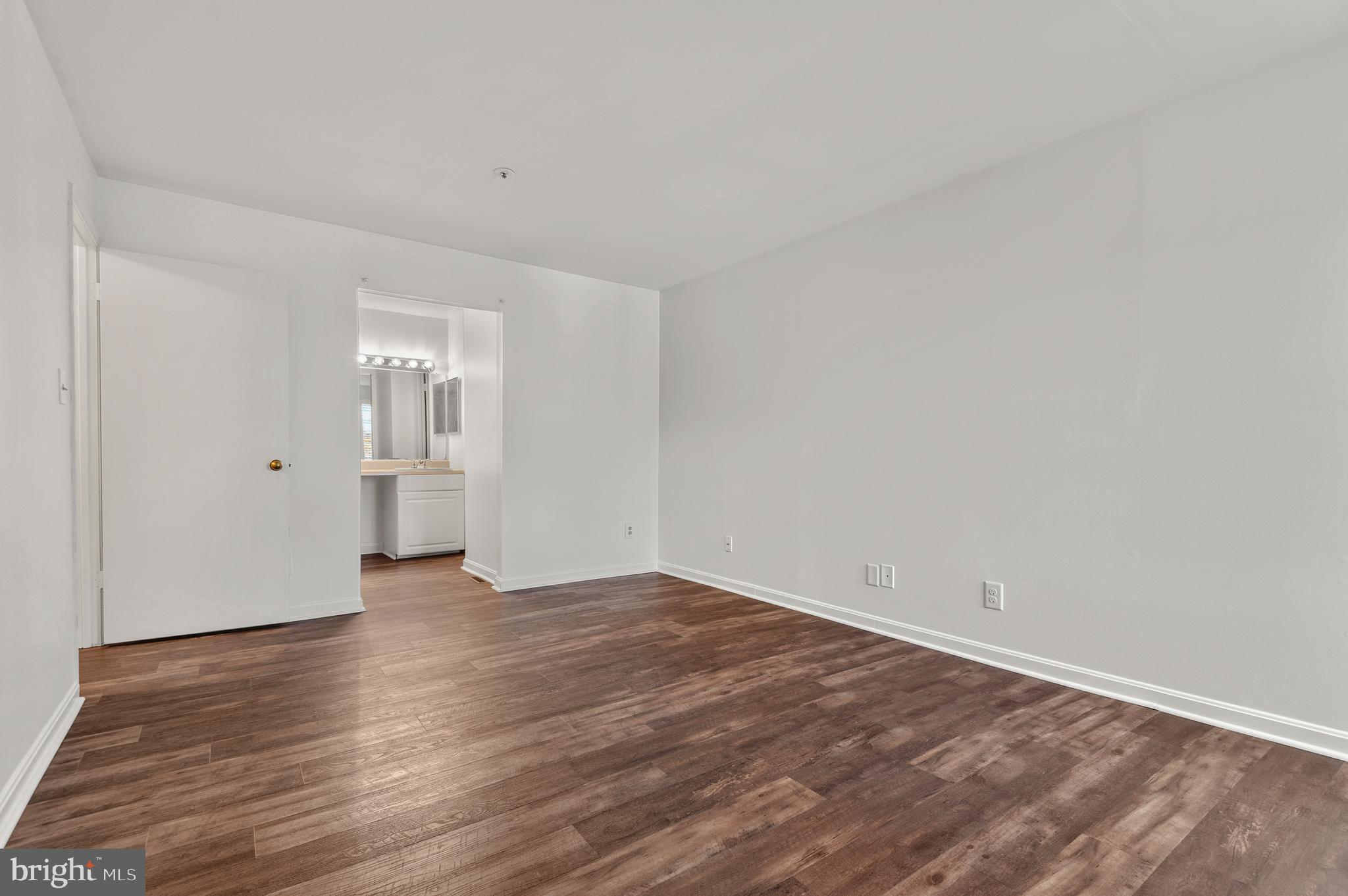 4942 Columbia Road, Unit 5 37 Columbia, MD 21044 - Photo 23 of 36 a view of an empty room and wooden floor