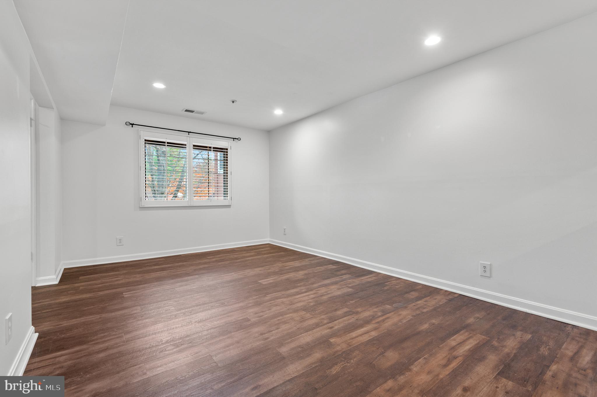 4942 Columbia Road, Unit 5 37 Columbia, MD 21044 - Photo 24 of 36 an empty room with wooden floor and a window