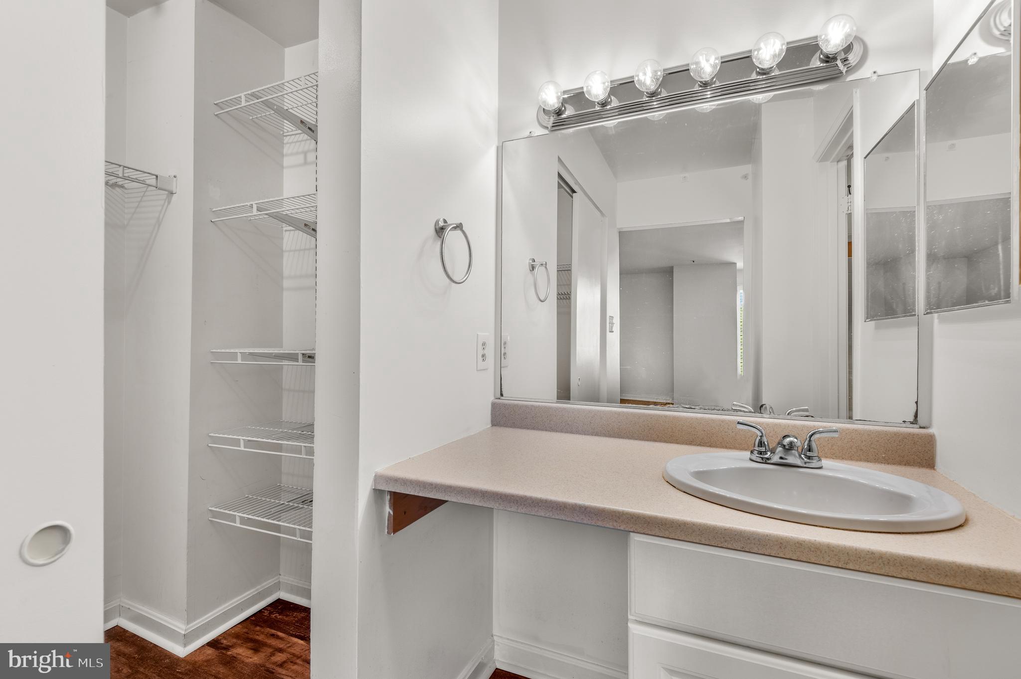 4942 Columbia Road, Unit 5 37 Columbia, MD 21044 - Photo 26 of 36 a bathroom with a sink and a mirror