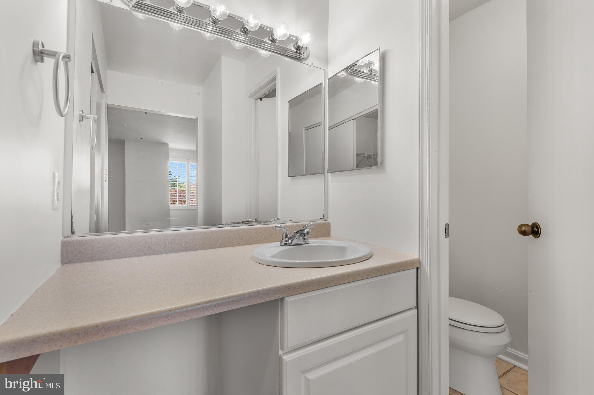 4942 Columbia Road, Unit 5 37 Columbia, MD 21044 - Photo 27 of 36 a bathroom with a sink a toilet and shower