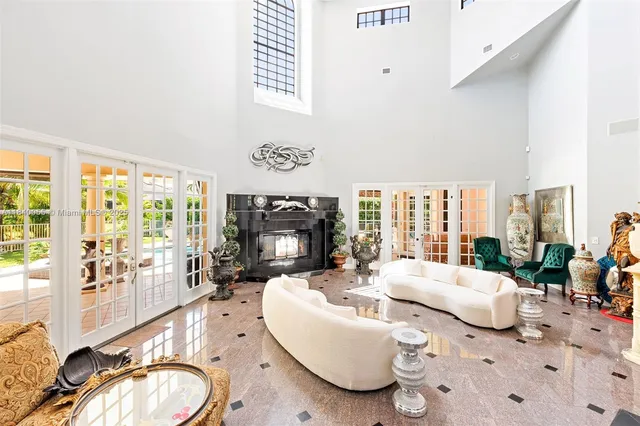 a living room with furniture large window and a fireplace