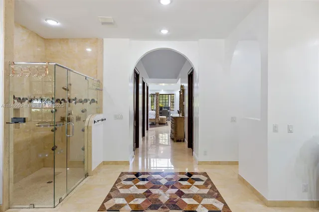 a view of a bathroom with a glass door shower and a sink