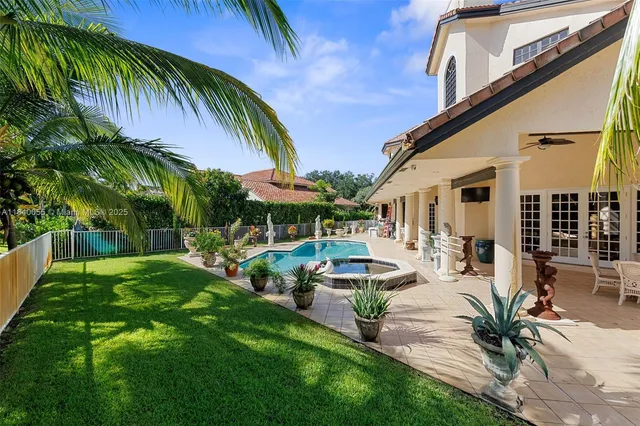 a view of a house with pool and chairs